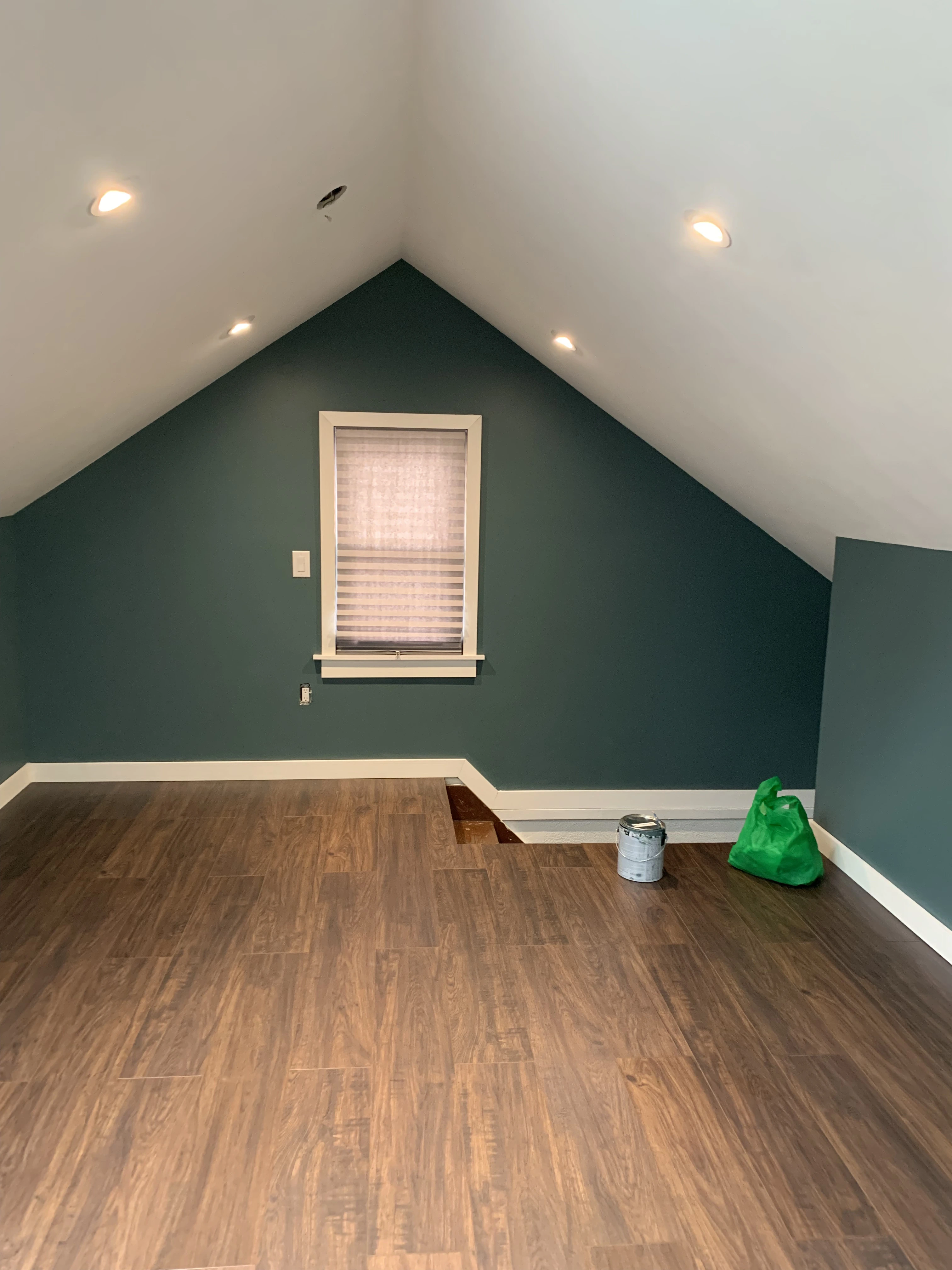 The opposite side of the attic which includes power outlets and a stairway