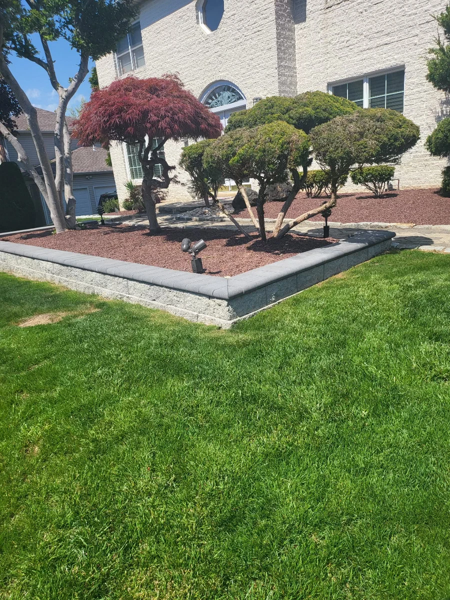 A hardscaping project where a stone raised bed for planting was made.