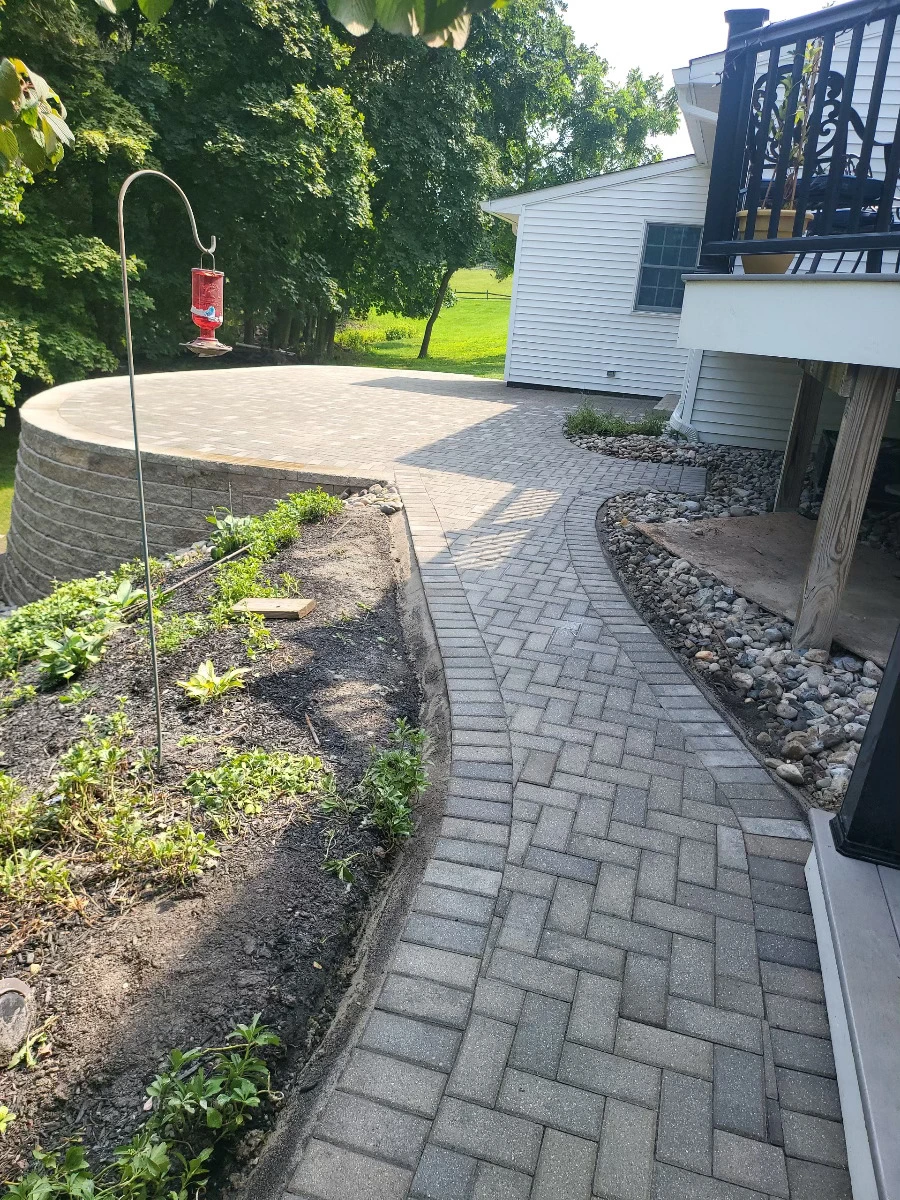 A hardscaping project where fresly laid stone flooring was added to a backyard patio.
