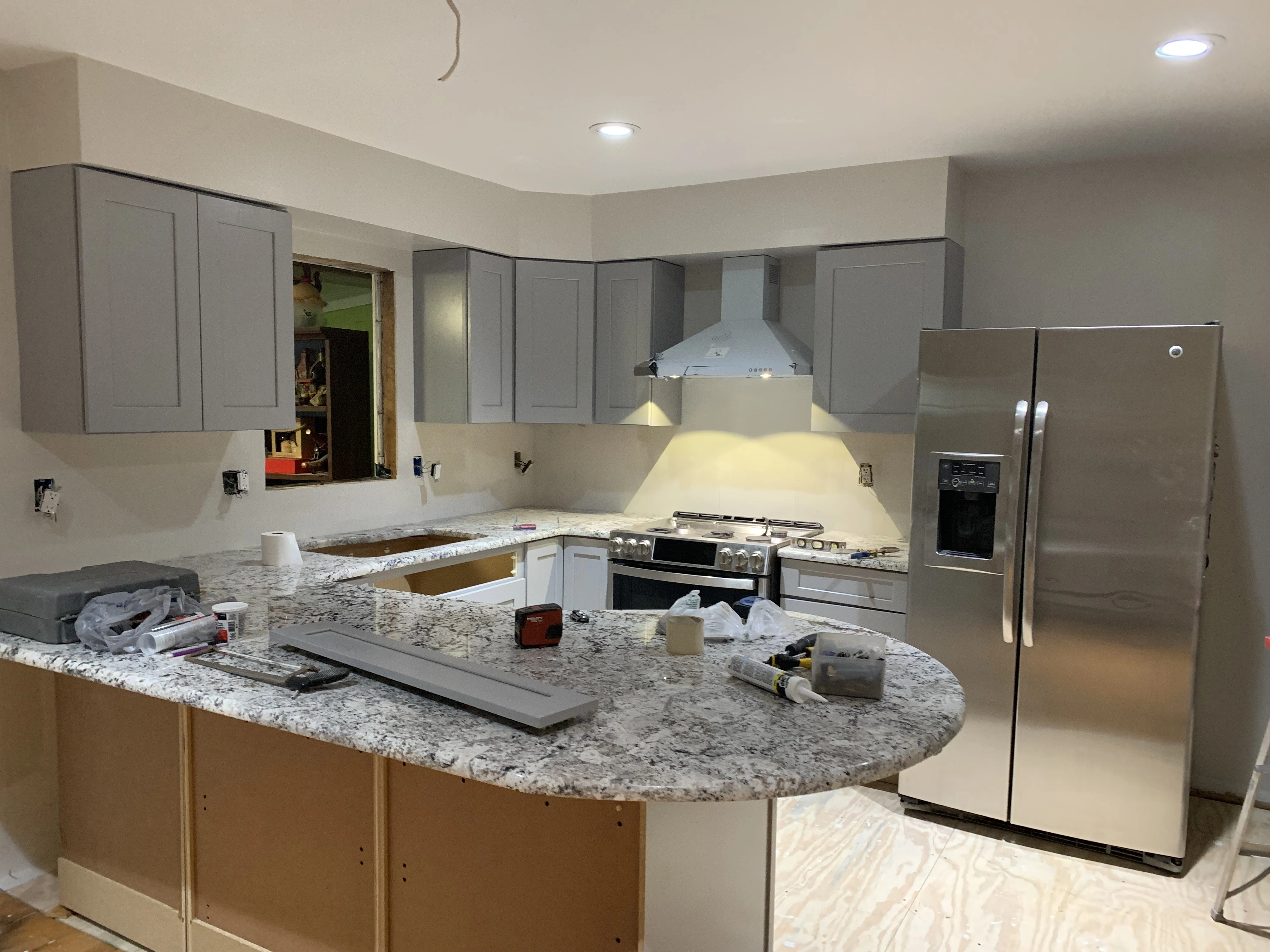 A newly renovated kitchen with new cabinets installed and a new kitchen island